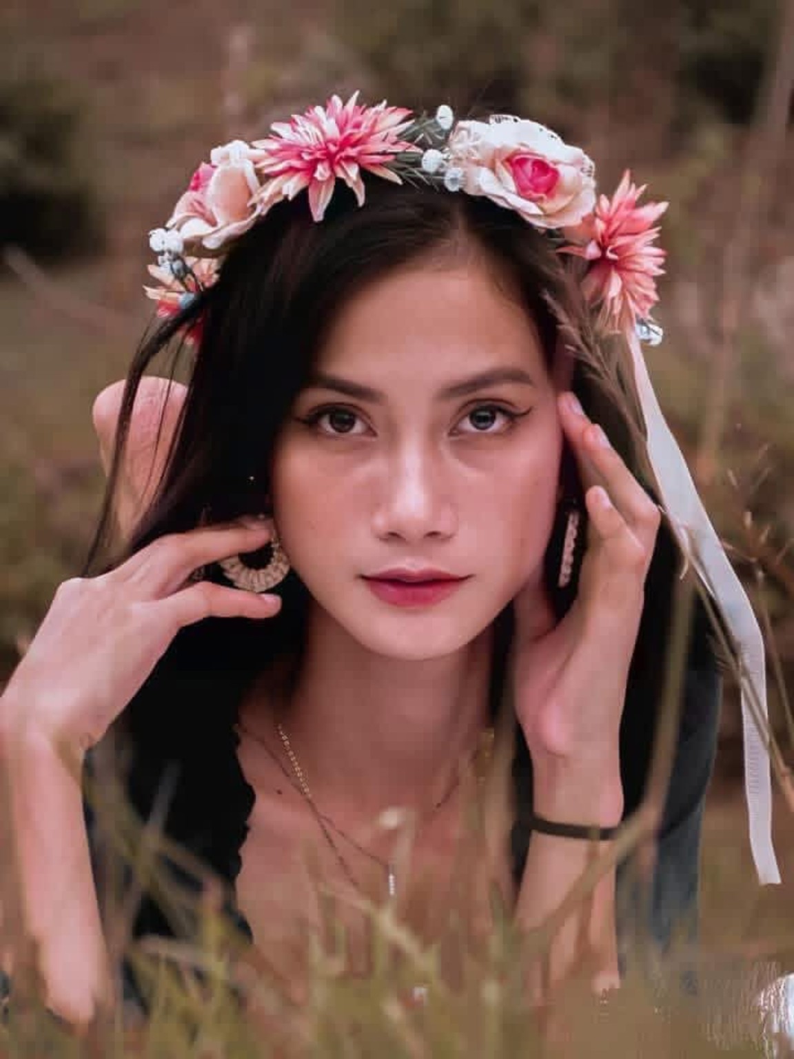 Close-up portrait of a woman wearing a flower crown